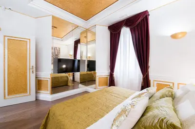 a bedroom with a king sized bed and a tv at THE IMPERIAL SUITE e THE BRICKS in Rome