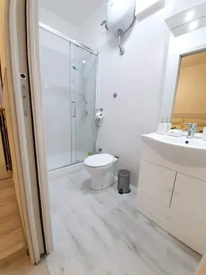 a bathroom with a shower and a toilet and a sink at Oscar suite home in Rome