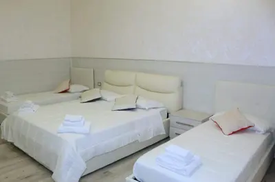a room with two beds with towels on them at Oscar suite home in Rome