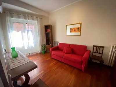 a living room with a red couch and a table at La Dimora in Rome