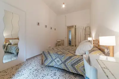 a bedroom with a bed and a mirror at GuestHost - Ad un passo da Villa Borghese Apartment in Rome