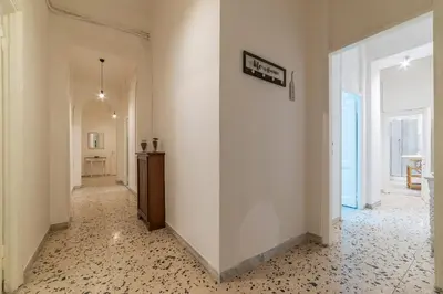 a hallway with a white wall and a hallway with a table at GuestHost - Ad un passo da Villa Borghese Apartment in Rome