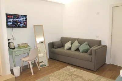 a living room with a couch and a table and a mirror at Nannarè Guest House in Rome