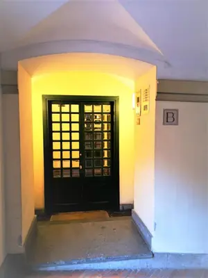 a black door in a room with a wall at Trevi Nice Holiday - Luxury Apartment in Rome