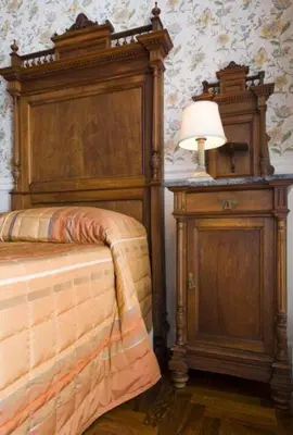 a bedroom with a bed and a dresser and a lamp at B&b Querini in Rome
