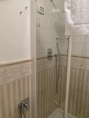a shower with a glass door in a bathroom at B&b Querini in Rome