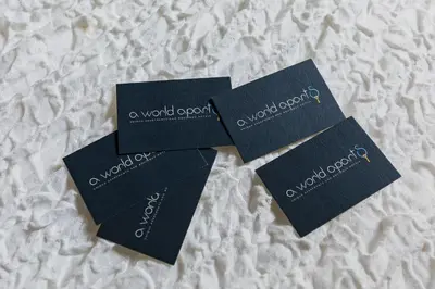 three blue cards sitting on top of a bed at A World Aparts - 55 Palermo in Rome