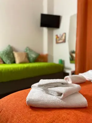 a pile of towels sitting on top of a bed at Trastevere & Gianicolo Sweet Rest in Rome