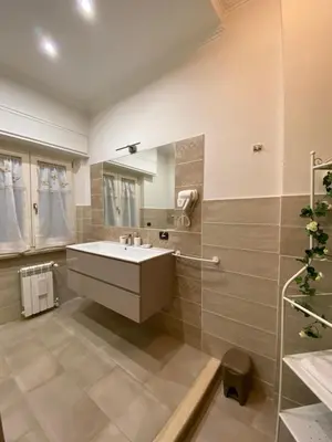 a bathroom with a sink and a mirror at Trastevere & Gianicolo Sweet Rest in Rome