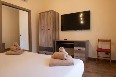 a bedroom with a bed and a flat screen tv at JSK Suite in Rome