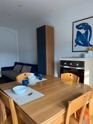a dining room with a wooden table and chairs at Home of Joy - Vatican in Rome
