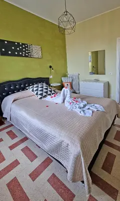 a bedroom with a large bed with a stuffed animal on it at GuestHouse Martin in Rome