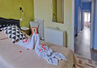 a bedroom with a bed with clothes on it at GuestHouse Martin in Rome