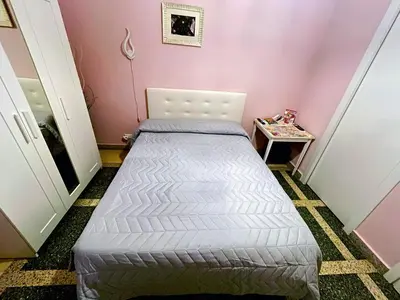 a small bedroom with a bed in a pink room at GuestHouse Martin in Rome