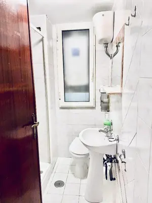 a white bathroom with a toilet and a sink at Center Rome Termini Rooms & Apartment Sale in Rome