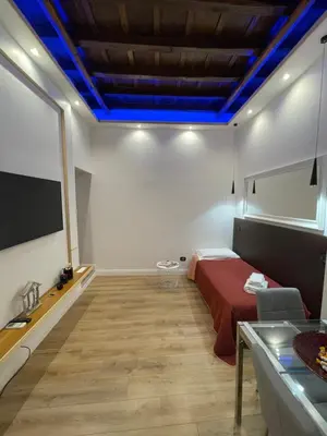 a room with a bed and a tv on the wall at Elian Apartament In The Center of Rome in Rome