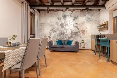 a kitchen and dining room with a table and chairs at Suite Italy Roma in Rome