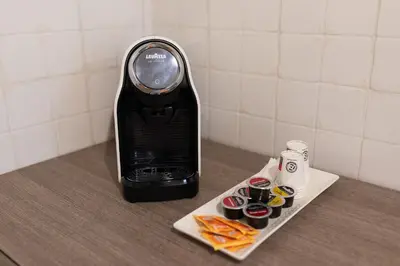 a food blender sitting on a counter with a tray of food at Mirabella Apartment in Rome