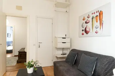 a living room with a couch and a painting on the wall at Mirabella Apartment in Rome