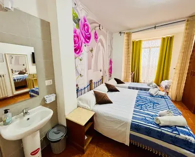 a bedroom with a bed and a sink and a bathroom at Milazzo Luxury Home roma in Rome