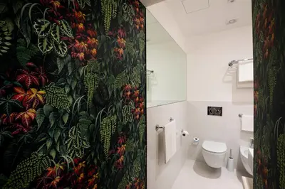 a bathroom with a shower curtain with a toilet at Vicario Suites in Rome
