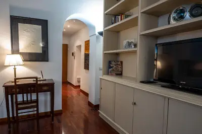 a living room with a flat screen tv and a entertainment center at Appartamento Margherita 2 in Rome