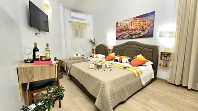 a bedroom with two beds and a flat screen tv at A Casa Simpatia in Rome