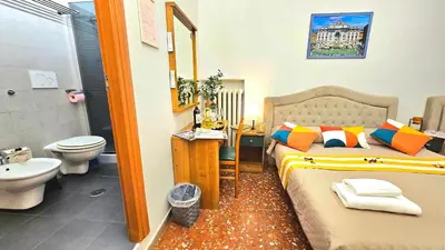 a bathroom with a bed and a toilet and a sink at A Casa Simpatia in Rome