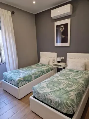 two beds sitting next to each other in a room at Home K&Y - Aurelio in Rome