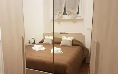 a bedroom with a bed with two towels on it at Trastevere Sweet Home in Rome