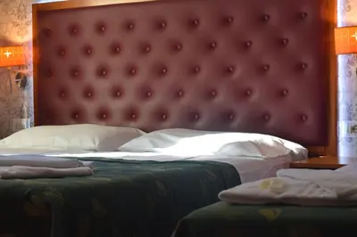 a bedroom with a large bed with a red headboard at A&C Much More II in Rome