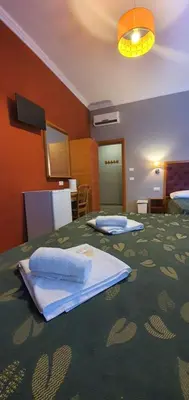 a hotel room with two beds with towels on it at A&C Much More II in Rome