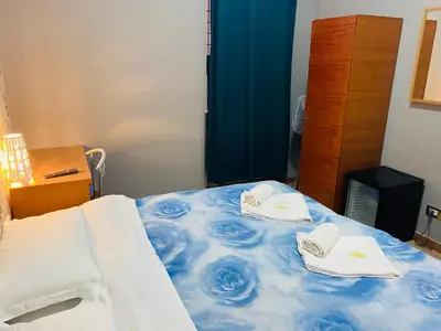 a bedroom with a bed with towels on it at A&C Much More II in Rome