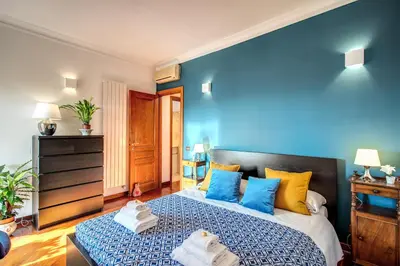 a blue bedroom with a bed with towels on it at FRESH HOUSE MONTI in Rome