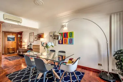 a dining room with a glass table and chairs at FRESH HOUSE MONTI in Rome