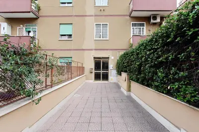 a walkway in front of a building at Martino Delightful Apartment in Rome