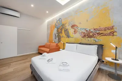 a bedroom with a bed and a painting on the wall at B-STAY Via Milano 52 in Rome