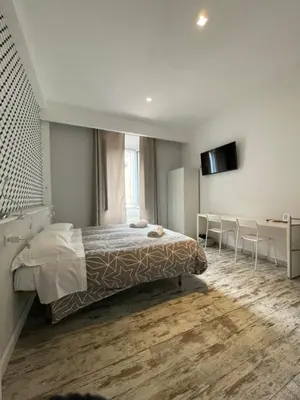 a bedroom with a bed and a table and a desk at Moshi Moshi in Rome