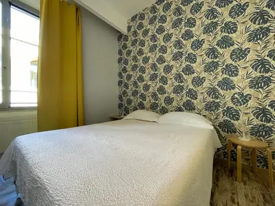 a bedroom with a bed and a wall with a wallpaper at Moshi Moshi in Rome