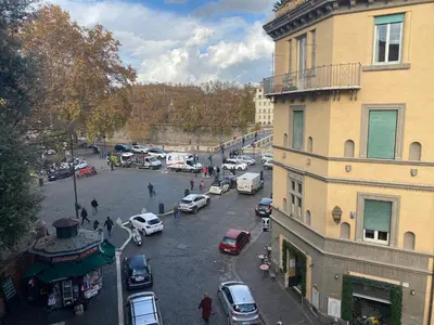 a city street with cars parked in a parking lot at Arc Trilussa 44 in Rome