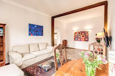 a living room with a couch and a table at Cavour Attic with terrace in Rome