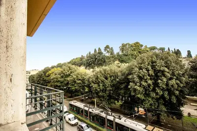 a view of a train station with trees and cars at DOWNTOWN SRL - Borghese Green in Rome