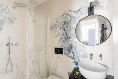 a bathroom with a sink and a mirror at ROMAC Trinity - 3bdr apartment with Sauna & Jacuzzi in Campo de Fiori in Rome