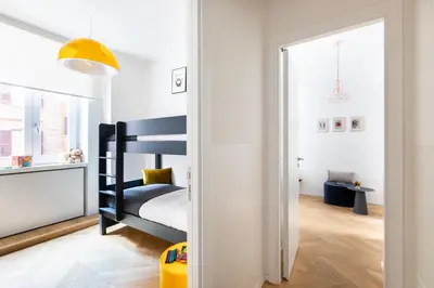 a childs bedroom with a black bunk bed at ROMAC Trinity - 3bdr apartment with Sauna & Jacuzzi in Campo de Fiori in Rome