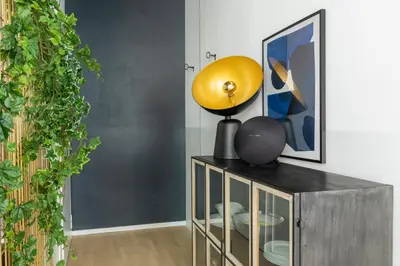 a yellow lamp sitting on top of a wooden cabinet at ROMAC Trinity - 3bdr apartment with Sauna & Jacuzzi in Campo de Fiori in Rome