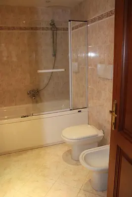 a bathroom with a toilet and a glass shower at Colosseum New Charming Apartment in Rome