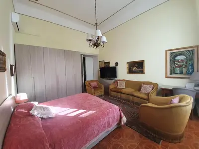a bedroom with a bed and a living room at Luxury San Giovanni in Rome