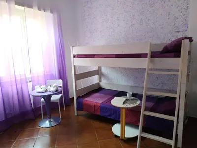 a small room with a bunk bed and a table at B&B Claudia a Monteverde in Rome