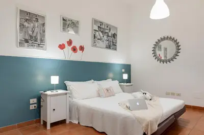 a bedroom with a bed with a laptop on it at Trastevere In Love in Rome