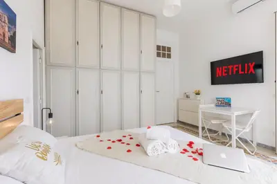 a bedroom with a bed with a laptop and a desk at Trastevere In Love in Rome